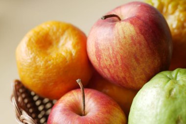 Elma ve portakalı turuncu arka planda bir kaseye koy. ..