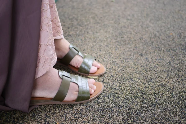 close up of girls feet wearing sandal outdoor .