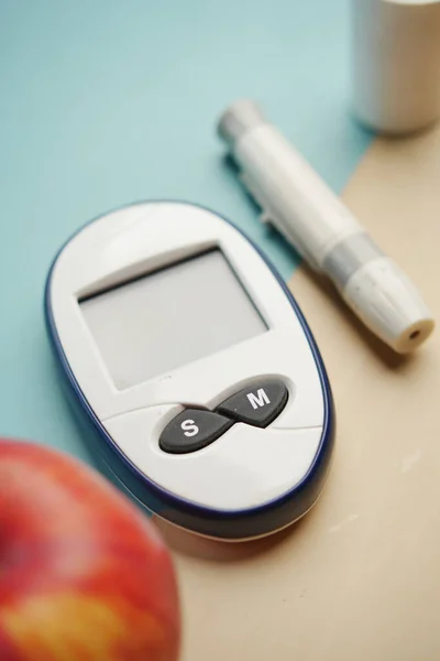 diabetic measurement tools, apple on table .