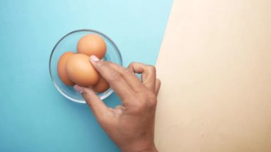  top view of hand pick eggs in a bowl.,