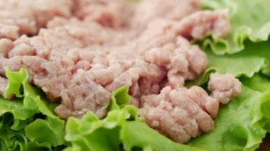 close up of beef mince on a chopping board on table .