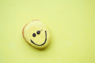 smile face chocolate donuts on yellow background ,