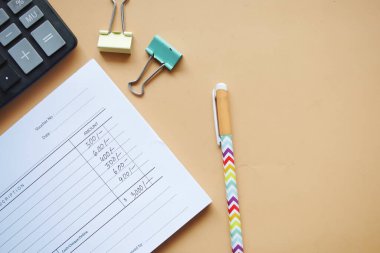  A man writes payment due in a paper form .