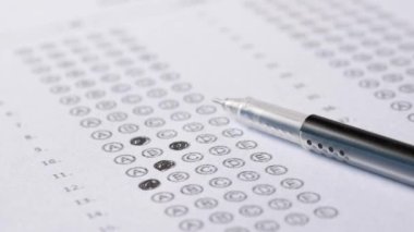 Test exam concept, pencil writing answer on paper .