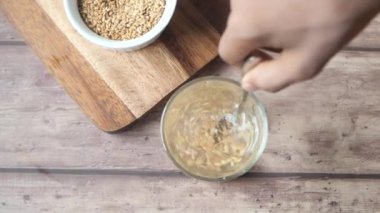 slow motion of mixing flax seed with water .