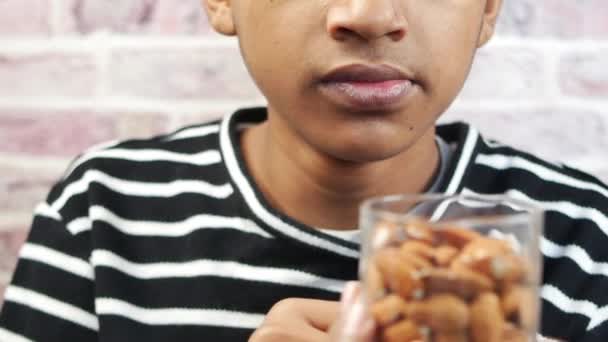 Boy Eating Almond Nuts Close — Vídeo de Stock