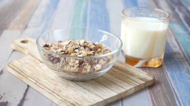 granola Musli and glass of milk on table ,