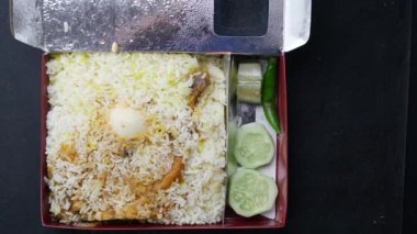  mutton biryani meal in take away packet .