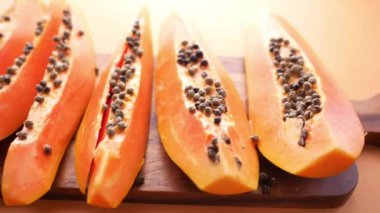 Kesme tahtasının üzerinde bir parça papaya .