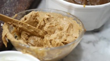 close up of fresh peanut butter in a container ,