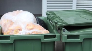 Bag with garbage and rubbish bin,