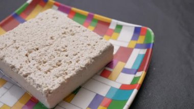 close up of Tofu on a plate on table .