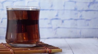 soft drinks with a ice cube in a glass ,