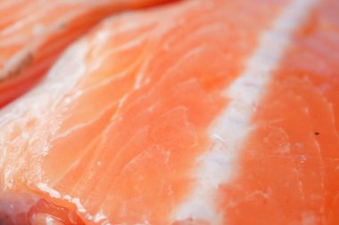 Raw, fresh salmon steak on a plastic packet on table ,