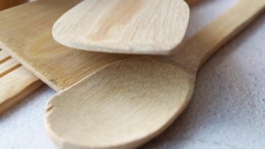 wooden cutlery fork and spoon on a chopping board on table ,