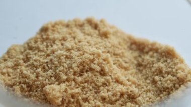 spoon pick brown sugar from a container ,