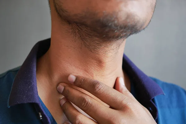unrecognized man suffering throat pain close up .