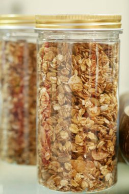 granola Musli in a transparent jar on table .