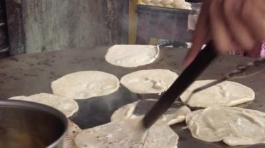  cooking roti chapati on a big cooking pan ,