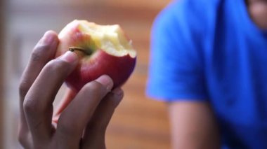  boy eating a apple close up ,