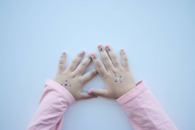 top view of baby hand on table .