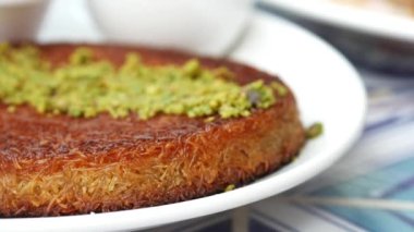 kunafa with a wipe cream on a plate