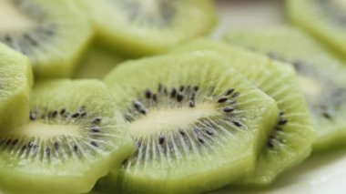 Ripe half kiwi fruit on a plate .