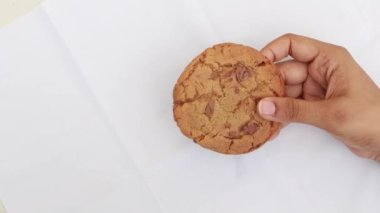 overhead view of holding a sweet cookies on white ,