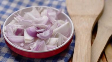 red onion in a bowl on table .