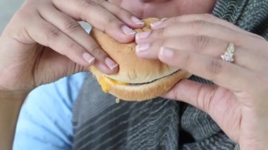 women hand holding beef burger top view ,