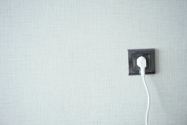 stock image  white color power cord cable plugged into wall .