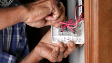 Electrician installing light switch in home