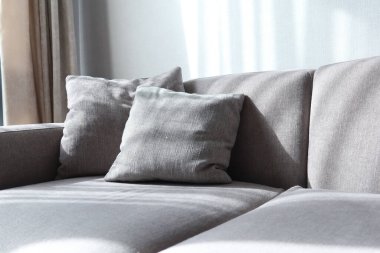modern grey sofa with pillows in living room at home. High quality photo