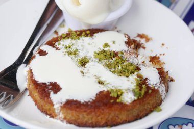 kunafa with a wipe cream on a plate