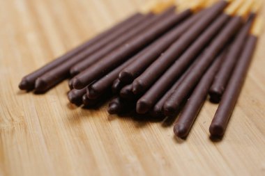 almond nut dark chocolate stick on table .