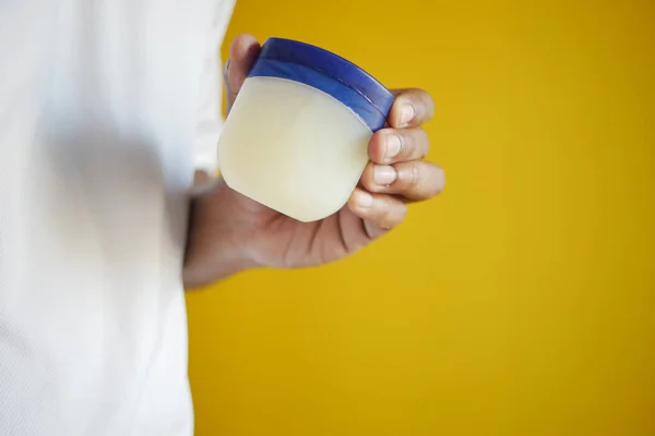 stock image  Close up of man hand using petroleum jelly .