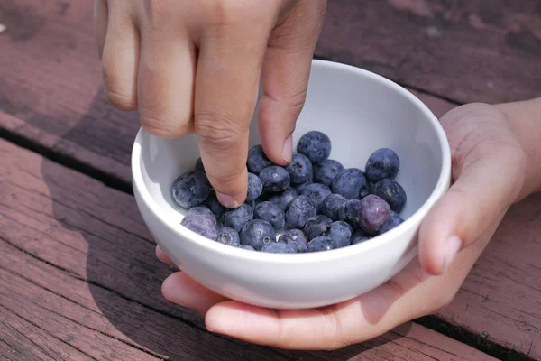women hand pick blue berry fruit ,
