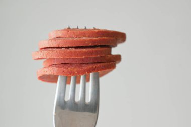 Mini Sausage in a red color bowl on white .