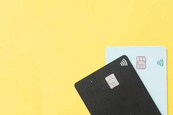 wireless bank card on yellow background , top view