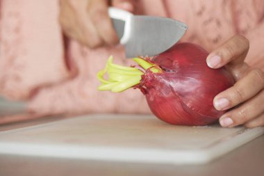 red onion in a bowl on table .