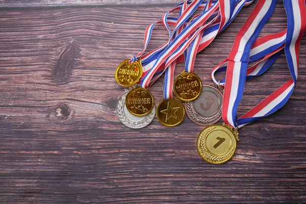 stock image First Place Throphy on wooden background 