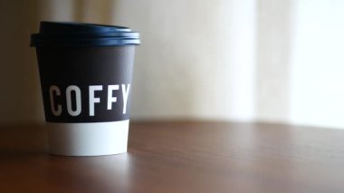 take away paper coffee cup o on cafe table ,
