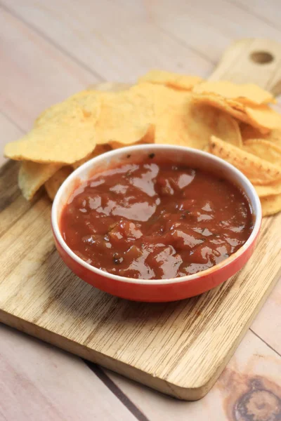 a bowl of chips and salsa on table