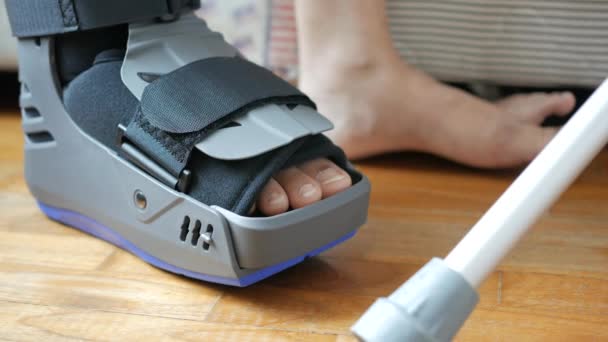 グレーのプラスチック製のブーツの足首ブレースの怪我で足を骨折 — ストック動画