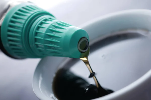 stock image Bottle of maple syrup pouring close up .