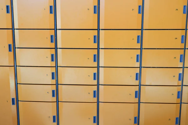 stock image orange color storage box in public place. safe storage locker for shopping malls