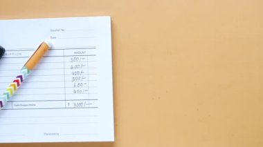  A man writes payment due in a paper form .