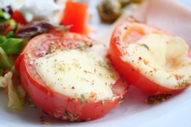 Tomatoes stuffed with cheese from the oven.