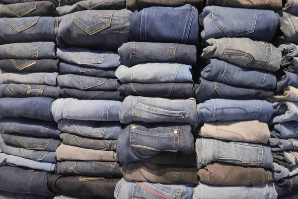 Stock image Stack of various blue jeans