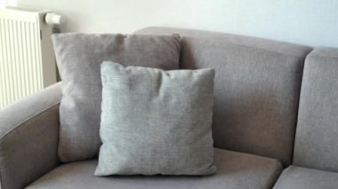 modern grey sofa with pillows in living room at home. High quality photo
